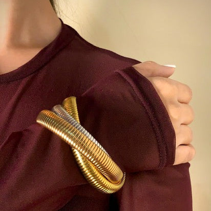 A girl in her 20s wearing the Trina Bangle over her sleeve - jewelry by Adiva Jewelry