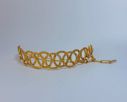 Model wearing a handcrafted gold-toned choker necklace with interlocking oval loops – statement semi-fine jewelry by Adiva Jewelry