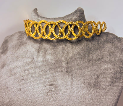 Model wearing a handcrafted gold-toned choker necklace with interlocking oval loops – statement semi-fine jewelry by Adiva Jewelry