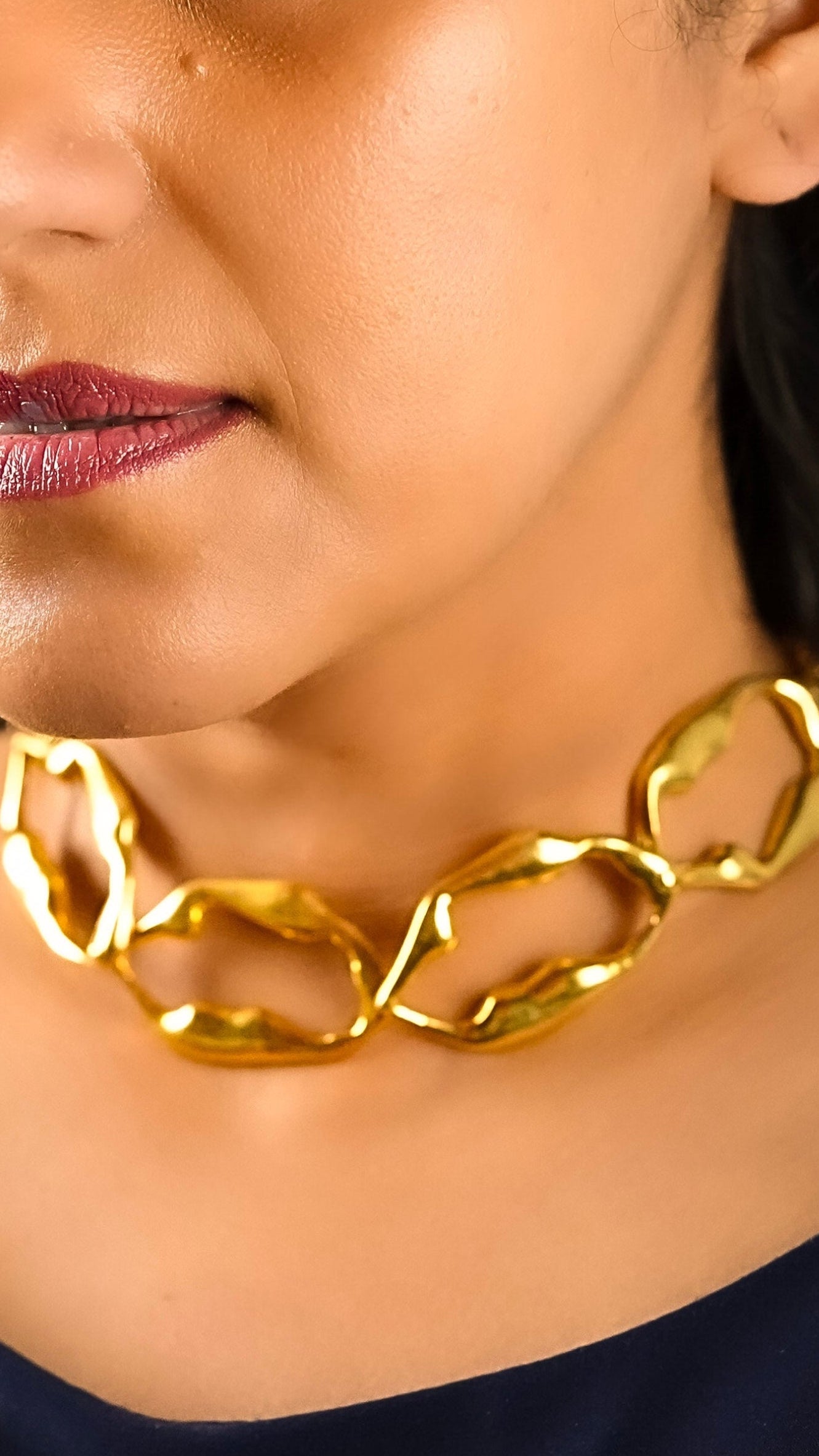 Close up of a woman wearing the Aria necklace of Adiva jewelry with a formal dress