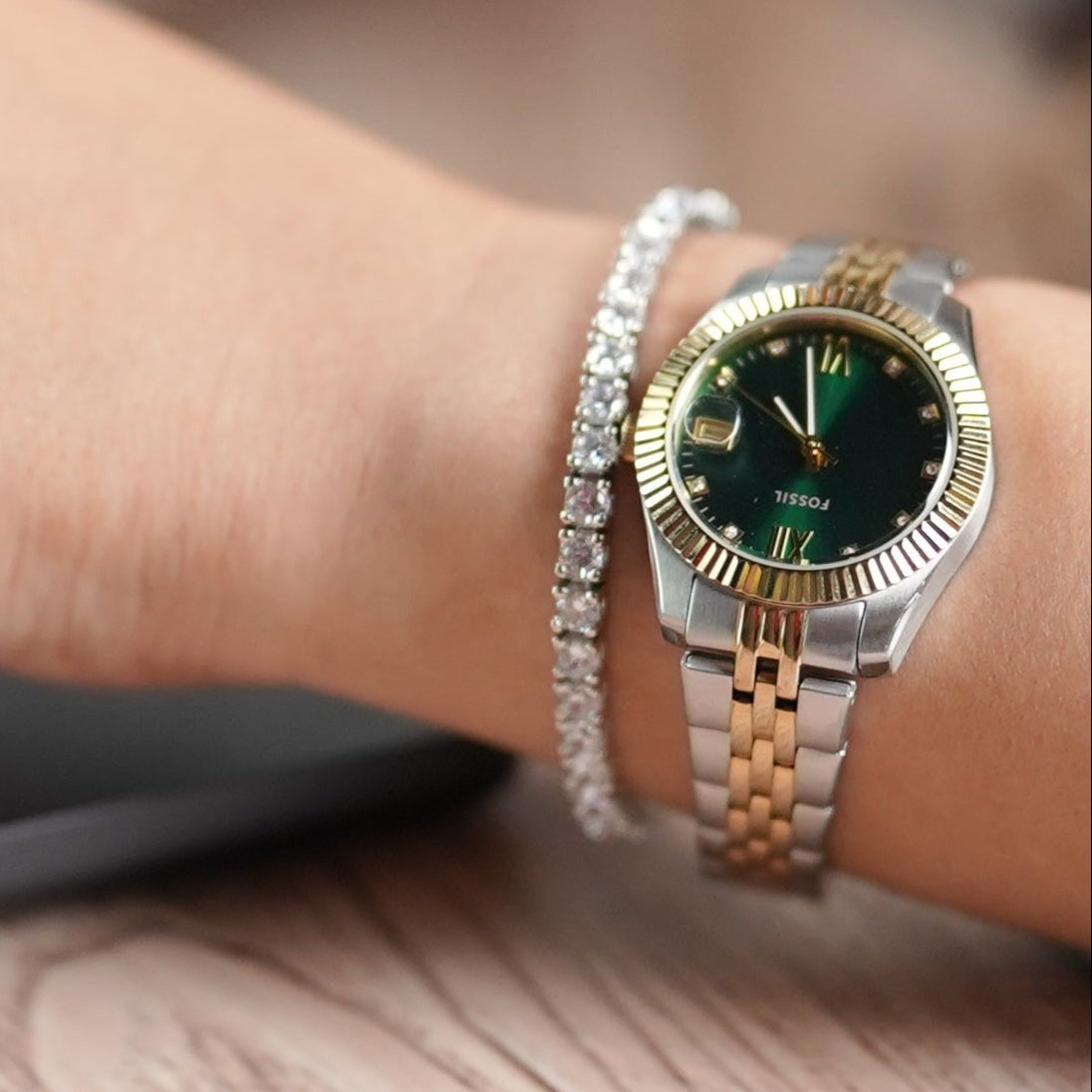 Woman in a corporate office working on a laptop wearing a tennis bracelet set in sterling silver with high rhodium polish - by Adiva Jewelry 