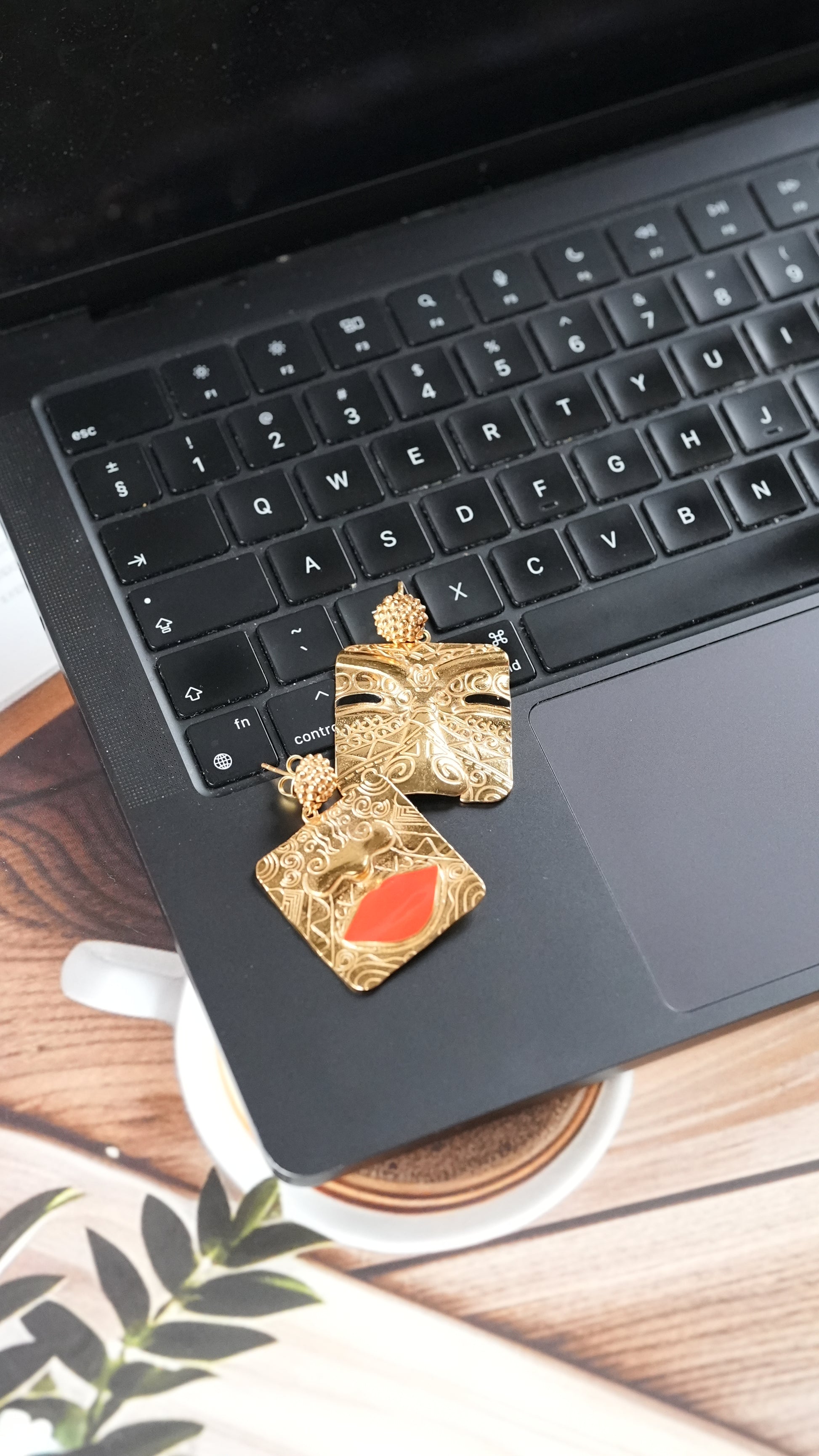 Gold-toned statement earrings with  a tribal face and lips motif – handcrafted using skin-safe brass by Adiva Jewelry