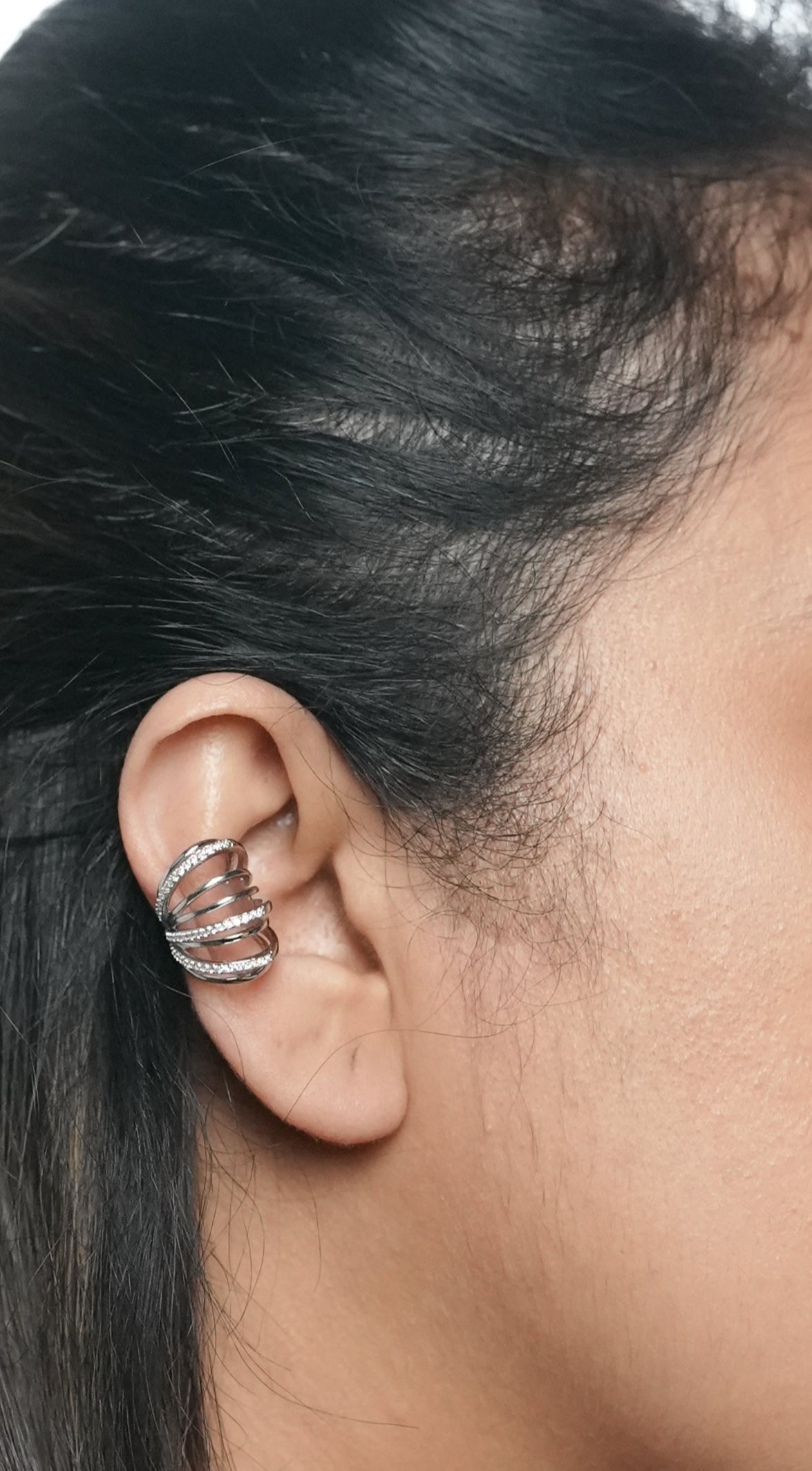 Close-up of a person wearing ear cuff in rhodium polish by Adiva Jewelry