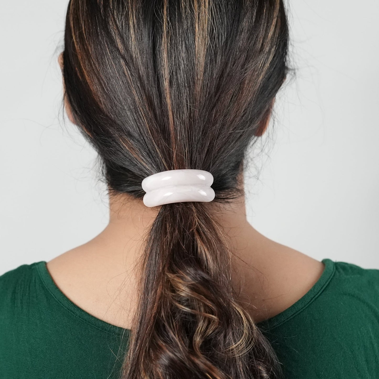 A girl with long hair wearing a hair tie in pink color , perfect hair accessory for the fashion conscious woman- by Adiva Jewelry