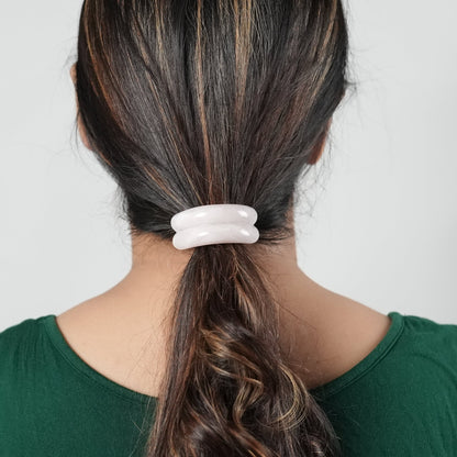 A girl with long hair wearing a hair tie in pink color , perfect hair accessory for the fashion conscious woman- by Adiva Jewelry