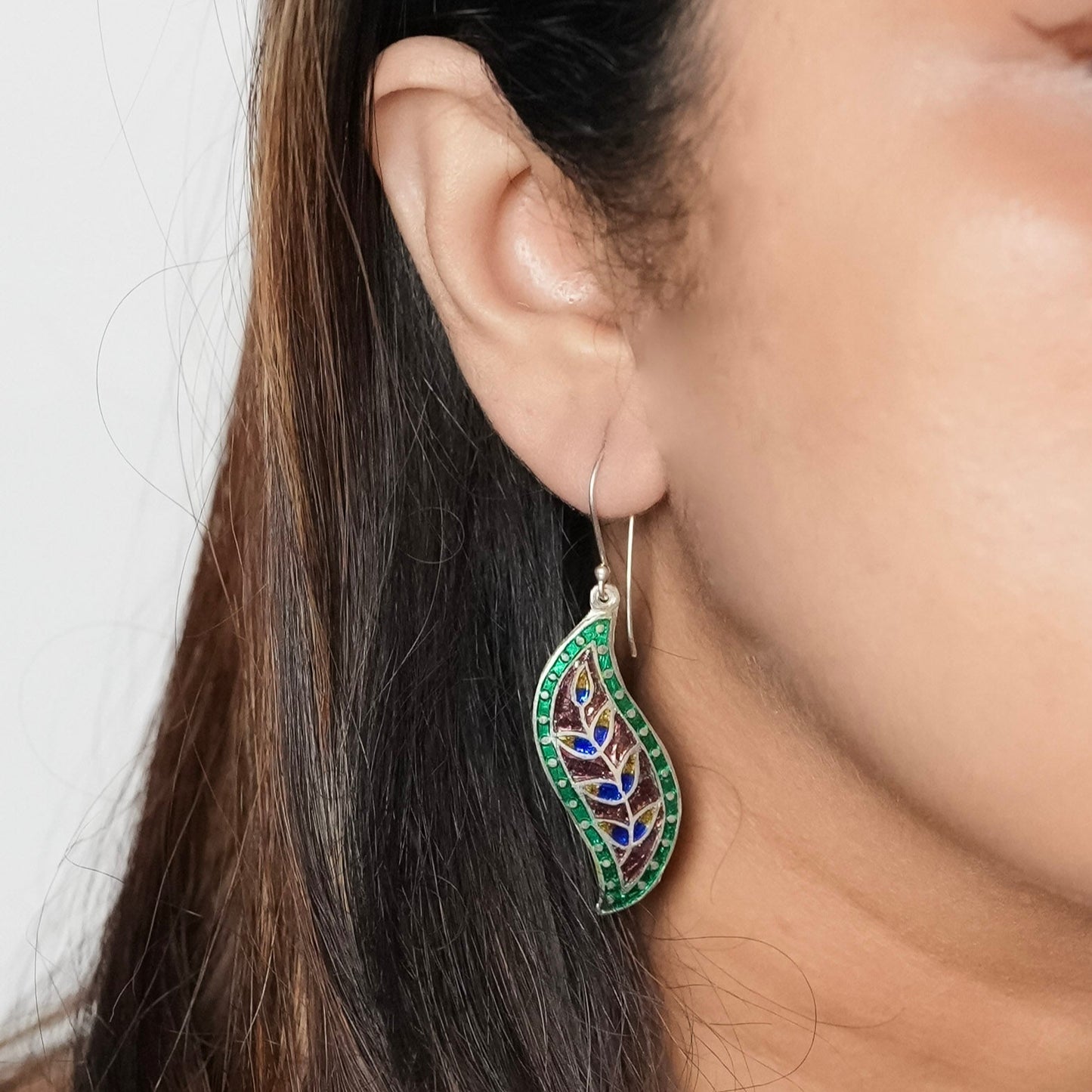 Close up of a woman wearing the Valley of Flowers earrings and getting ready to go out for a book reading.. Earrings made by Adiva Jewelry
