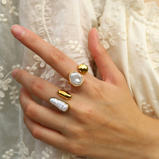 Elegant gold-tone statement rings with abstract pearl and molten metal designs, styled on hand for Adiva Jewelry — a modern lifestyle jewelry brand celebrating artistic fashion.