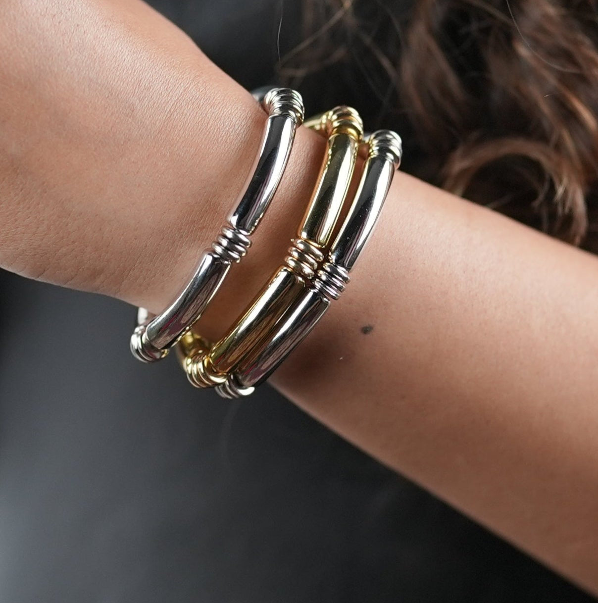 Woman in her late 20s getting ready to go out for a date night and wearing a three bangle set of Adiva Jewelry