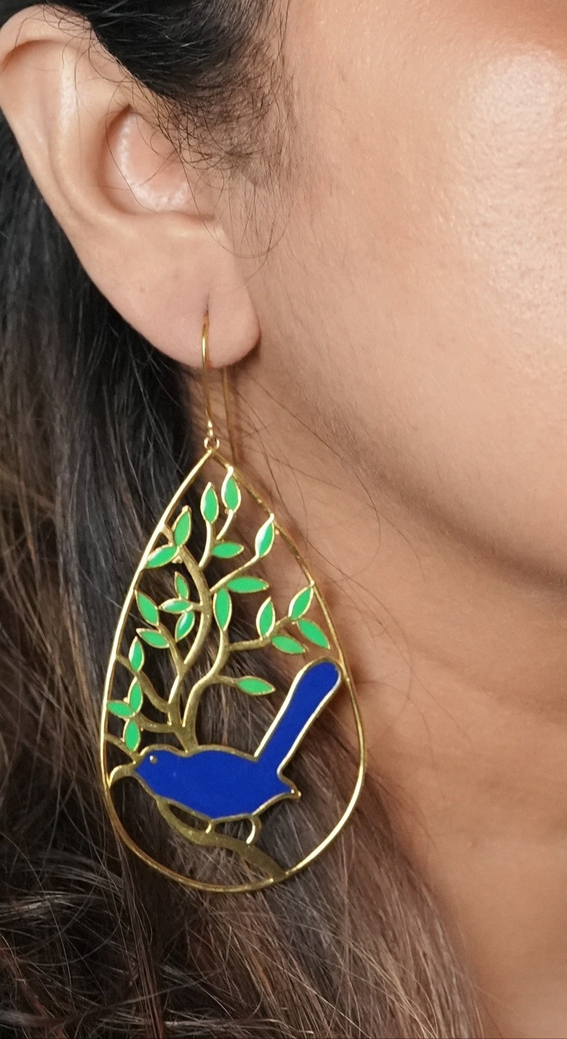 Handcrafted gold-toned statement earrings featuring a blue bird and tree motif – perfect party wear or a unique gifting choice from Adiva Jewelry